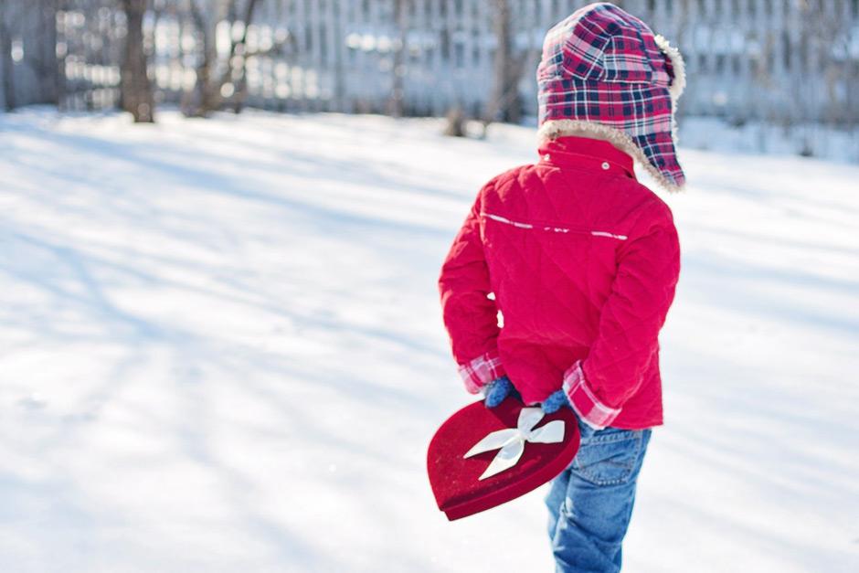 Valentine child carrying gift