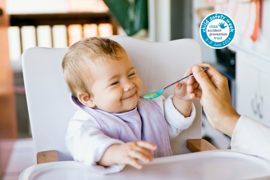 child in a highchair being fed